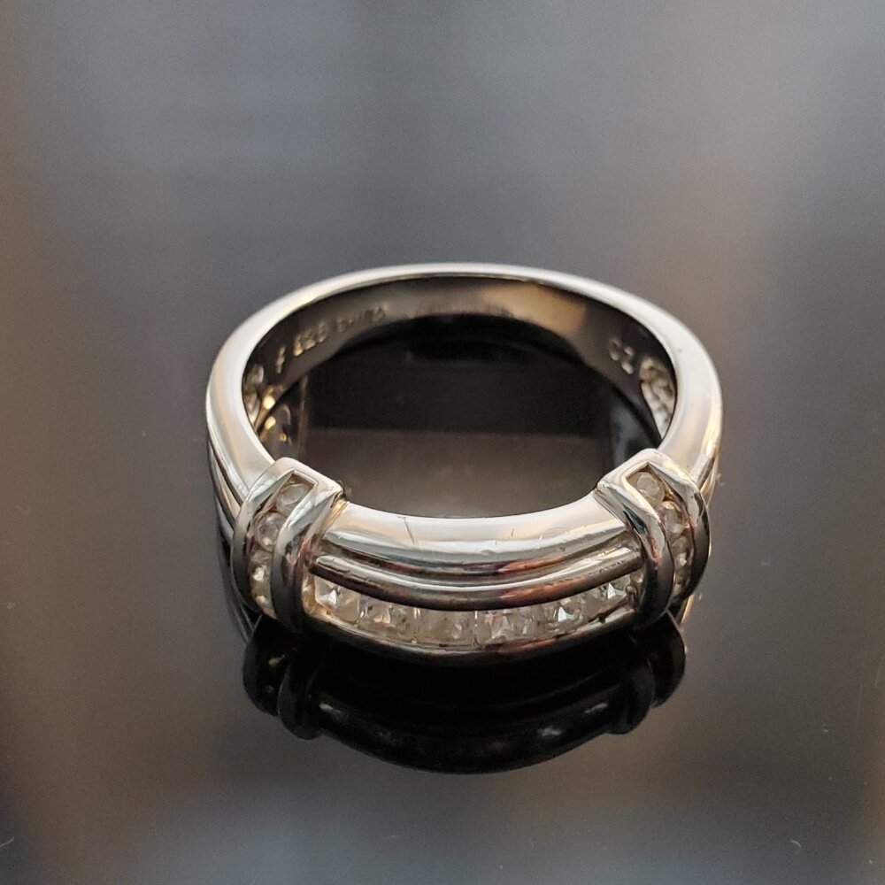 Silver ring decorated with clear square cut gemstones, size 8 band